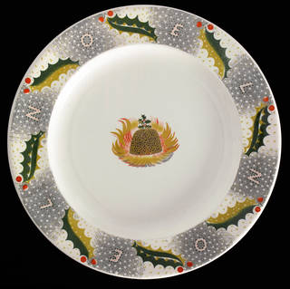 Christmas pudding plate with a flaming Christmas pudding in the middle, and holly around the edges.