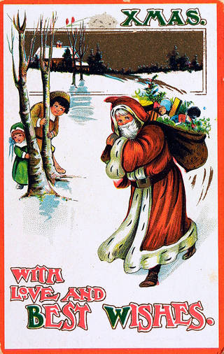 Christmas card featuring Santa with a bag of gifts, and two children peering at him from behind trees