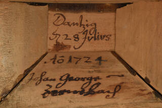 hand-written inscription on wooden carcass inside amber cabinet