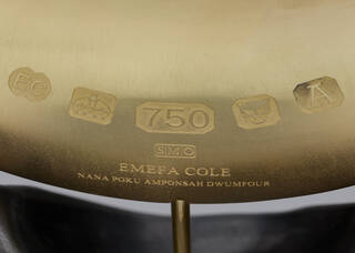 Detail of gold hallmarks and makers' marks on a gold sculpture