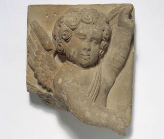terracotta relief of head and torso of cupid