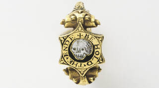 Gold and enamel memento mori ring with skull in centre