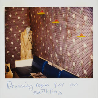 Polaroid photograph annotated by David Bowie with words 'Dressing room for an earthling'