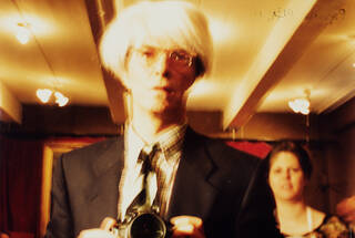 Colour photograph of David Bowie in costume as Andy Warhol in 'Basquiat'