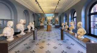 Photograph of down the length of the sculpture galleries at the V&A South Kensington