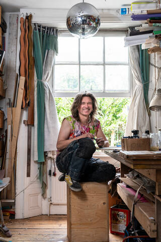 man sitting on a box in a studio