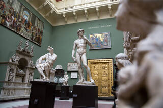 View of the Cast Courts at V&A South Kensington, featuring large casts of famous sculptures