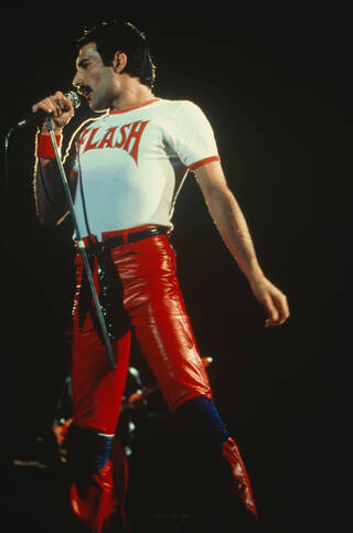 Freddie Mercury on stage wearing Flash t-shirt in white and red