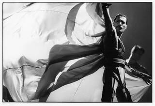 Black and white photo of Freddie Mercury performing