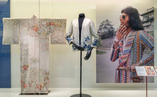 a kimono jacket and kimono on display alongside a photograph of Freddie Mercury